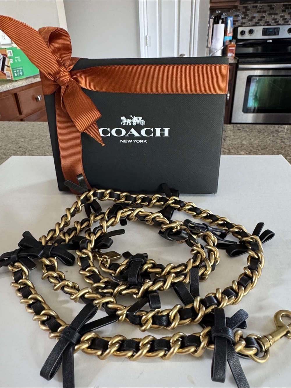 Coach Black Leather and Gold-Tone Chain Strap with bows